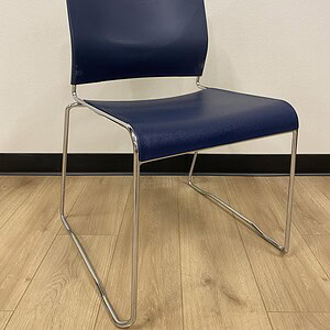 Navy blue stacking chair with a sleek design, ideal for office or conference room settings.