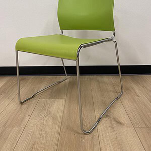 Lime green stack chair with metal frame, ideal for office or conference rooms.
