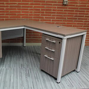 Modern L-shaped office desk with storage drawers, ideal for professional workspaces.