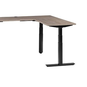 Modern L-shaped desk with black adjustable legs and wood finish.
