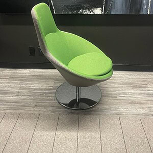 Swivel chair with green and grey upholstery and chrome base, modern office seating.