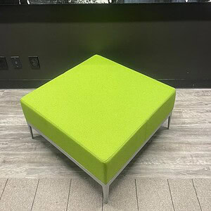 Green square ottoman for modern interior decor.
