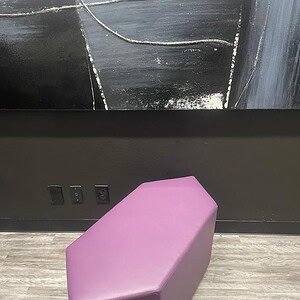Elongated purple vinyl ottoman from Cube World USA, perfect for modern interior decor.