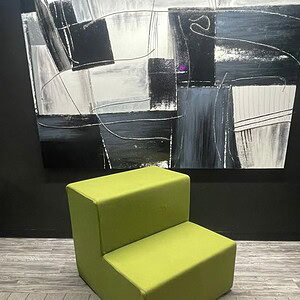 Big green lounge chair for modern interior decor and relaxation.