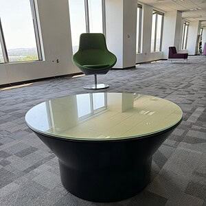 Topped modern end table with sleek black base, ideal for contemporary living spaces.