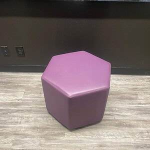 Hexagonal purple vinyl ottoman for modern interior decor. Perfect for seating or accent furniture in.