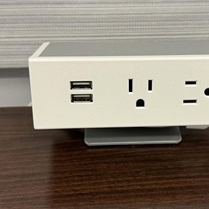 Mounted dual USB and power outlet for convenient charging and electrical needs.