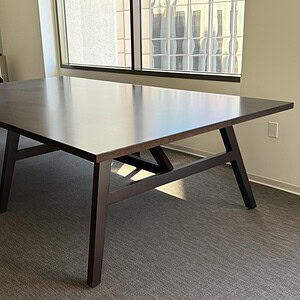 Black wood breakroom table for office or conference room use.