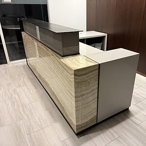 Reception desk with marble finish and modern design.