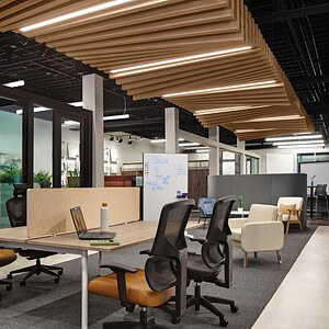 Office benching system with colorful, modular workstations in a modern workspace.