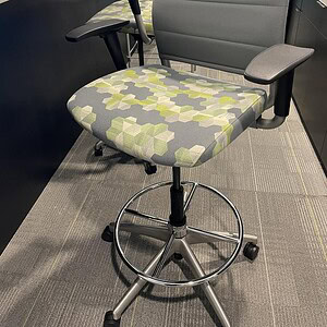 Office chair with modern geometric fabric pattern and chrome accents.