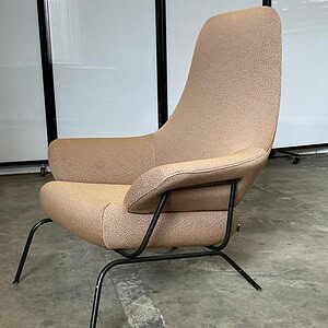 Luxurious Hon Tan lounge chair with a sleek black metal base, perfect for modern interiors and relax.