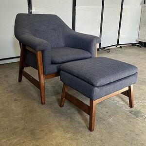 Blue lounge chair with matching ottoman for office or home relaxation.