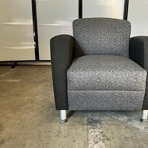 Grey and black modern lounge chair for stylish comfort.