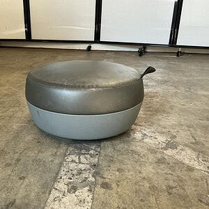 OFS Grey Leather Plush Ottoman with a sleek, modern design, perfect for contemporary living spaces.