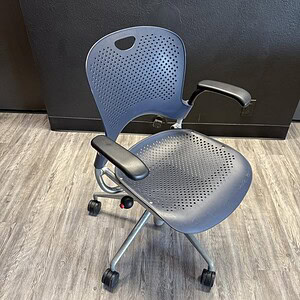 Herman Miller Caper chair with perforated backrest and adjustable armrests, ideal for modern office.