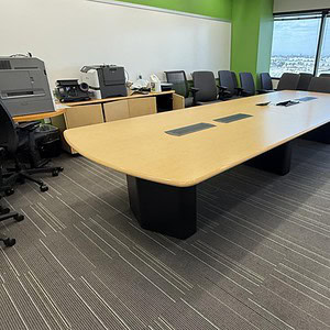 Modern conference room with Steelcase 14x5ft Boat White Oak powered table and office chairs.