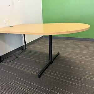 Modern Bullet Table with White Oak finish, ideal for office spaces.
