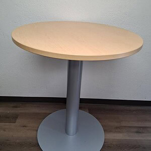 Modern 36-inch round bar height table with light wood top and gray base.