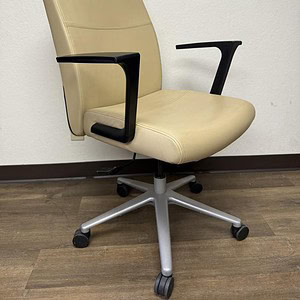 Cream leather conference chair with black armrests and adjustable height. Perfect for office meeting.