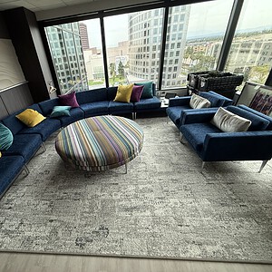 Arcadia 7-piece C.E.O. lounge set with colorful cushions in a city office with large windows.