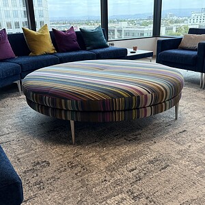 Color round ottoman for modern living spaces. Perfect for collaboration and stylish seating.