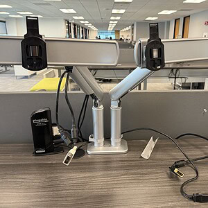 Dual monitor arm mounts for ergonomic workspace setup.