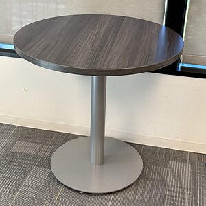 Modern Steelcase table with driftwood top and sleek metal base.