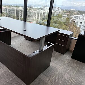 Adjustable height 7'x3' desk with credenza, perfect for modern office spaces and ergonomic work envi.