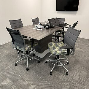Conference table with six chairs in a modern office setting.