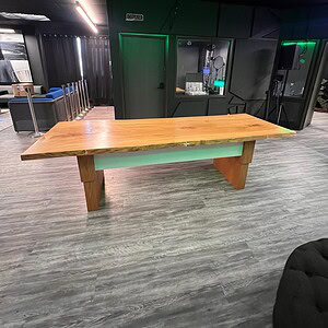 Height adjustable rustic-modern wooden desk with drawers for versatile workspace.