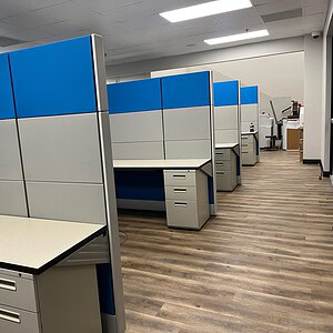 Modern blue and silver Ethospace cubicles in an office setting, 6x6x70 inches tall.