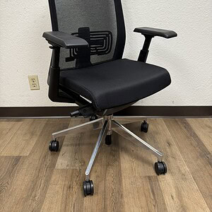 Office chair with black mesh back and lumbar support, chrome base, and adjustable armrests. Perfect.