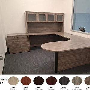 Shaped executive desk with multiple storage options.