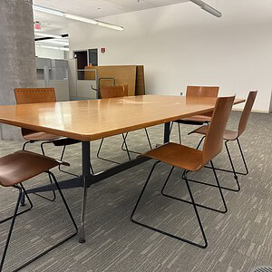 Herman Miller Eames authentic classic base with interchangeable top in office setting.