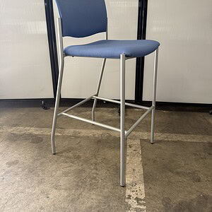 Square shaped barstool with sky blue fabric, ideal for commercial or home use. Durable metal frame a.