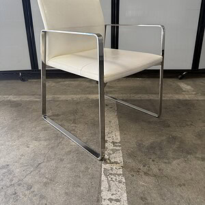 White leather guest chair with sleek chrome frame, ideal for office reception areas.
