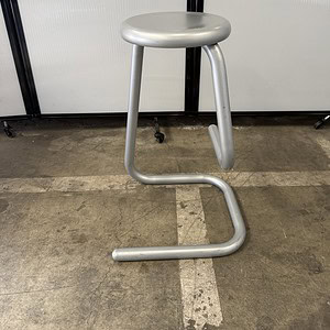Modern silver bar stool with curved base, 28-inch height, ideal for kitchen or bar areas.