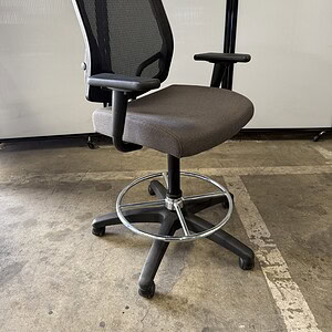 Ergonomic office stool with grey fabric seat, black mesh back, pneumatic height adjustment, and adju.