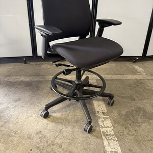 Black Steelcase Amia office chair with adjustable armrests and ergonomic design.