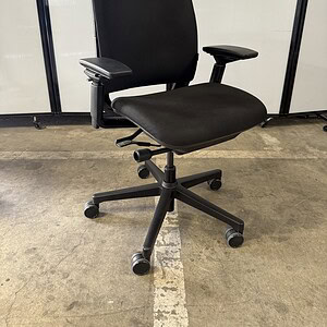 Black fabric fully loaded office chair with adjustable armrests and ergonomic design.