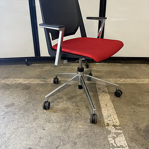 Office chair with chrome base, red fabric seat, and black perforated backrest. Perfect for modern wo.