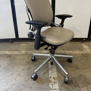 Office ergonomic chair with neutral leather and chrome base.