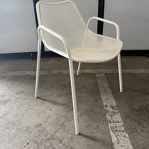 Outdoor white metal chair for patio or garden seating.