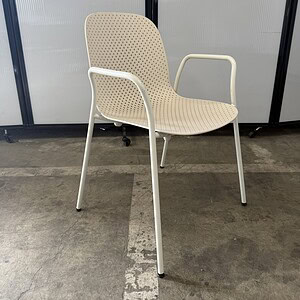 Outdoor cream perforated chair for patio or garden seating. Durable, stylish, and comfortable for ou.