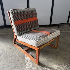 Outdoor lounge chair with solid wood frame, grey and orange fabric cushions, perfect for patio or ou.