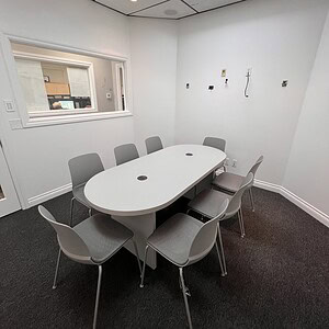OFS White Powered Conference Table in a modern office meeting room.