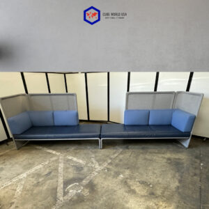 Modern acoustical sofa set with blue cushions and metal frame for collaborative spaces.
