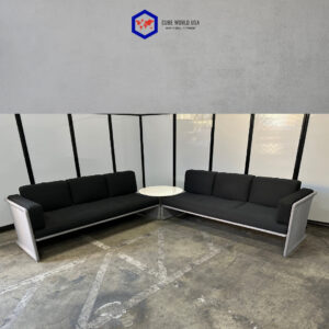 Modern black and grey acoustical sofa with white accents, ideal for office or lounge spaces.