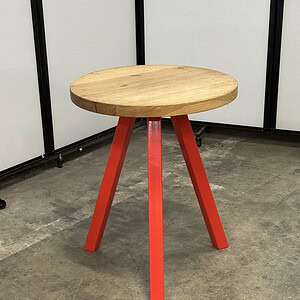 Knoll butcher block table featuring a 24" x 30" wooden top and vibrant red legs, ideal for modern di.